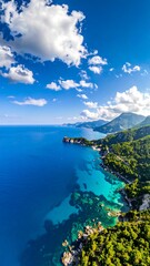 Aerial view of a stunning turquoise cove, bordered by lush green hills and blue sky