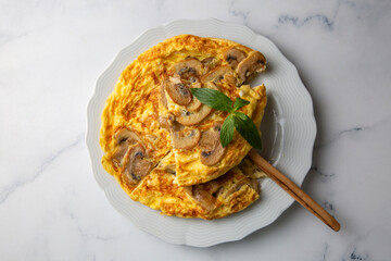 Frittata is an Italian type of omelet. Omelet with mushrooms cast-iron pan.