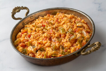 Turkish traditional menemen dish made with eggs, peppers and tomatoes