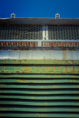 Close-up of rusty painted industrial metal grille