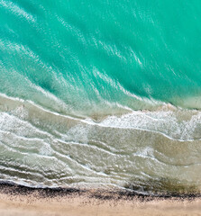 Fototapeta premium A blue clean water with waves, aerial top view of the ocean in a sunny day.
