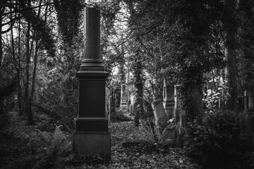 Vintage, retro photo of a tombstone in the Old Southern Cemetery (Alter S&uuml;dfriedhof) of Munich. Grainy, noisy, artistic monochrome image. Halloween, all saints concept