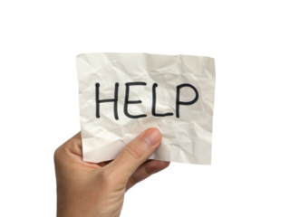 A hand holds a crumpled note with the word "HELP" prominently written on it.