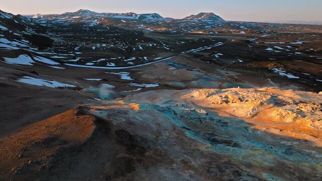 Aerial footage of Hverir geothermal area in North Iceland. Hot steam flows through fumaroles in a colourful volcanic valley.