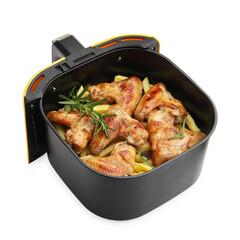 Grilled chicken wings and french fries with rosemary in air fryer basket isolated on white
