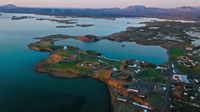 Drone footage of Lake Myvatn area in North Iceland. The volcanic pseudocraters and surrounding wetlands are illuminated by golden light.