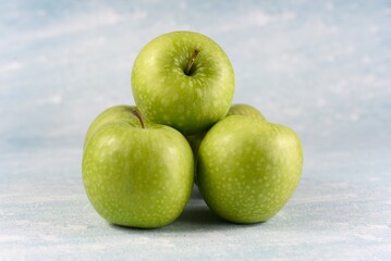 Image of five granny smith apples.