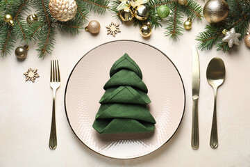 Festive table setting with Christmas decor on beige background, flat lay