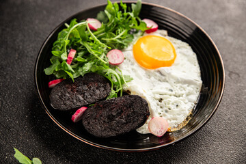 Eggs breakfast black pudding, egg, vegetables, arugula portion size natural product tasty snack fresh delicious gourmet food background on the table rustic top view copy space