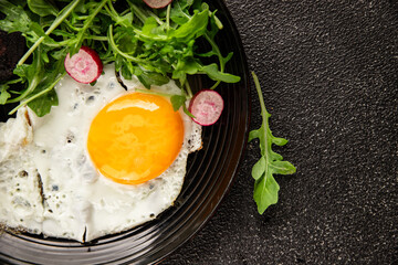 Eggs breakfast black pudding, egg, vegetables, arugula portion size natural product tasty snack fresh delicious gourmet food background on the table rustic top view copy space