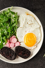 Eggs breakfast black pudding, egg, vegetables, arugula portion size natural product tasty snack fresh delicious gourmet food background on the table rustic top view copy space