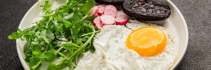 Eggs breakfast black pudding, egg, vegetables, arugula portion size natural product tasty snack fresh delicious gourmet food background on the table rustic top view copy space