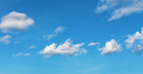 Bright blue sky with scattered white clouds, evoking calmness, clarity, and the peaceful beauty of a sunny day.