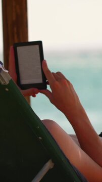 Relaxing by the beach while reading on a sunny day with ocean view and gentle waves in the background