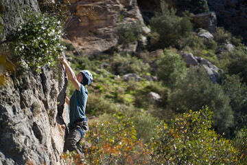 Obraz premium Man is climbing, hiking in the mountains.