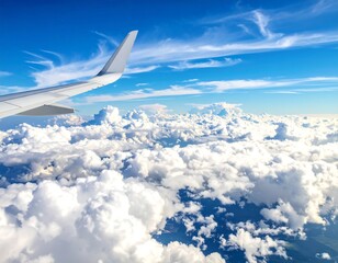 Airplane wing above a fluffy sea of clouds under a bright blue sky on a sunny day