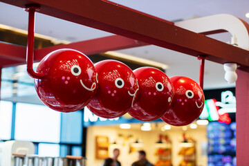 Colorful hanging decorations, Bright spheres decorate shopping area, Vivid ornaments suspended over food court