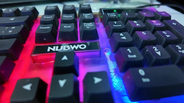 Gaming Keyboard with Backlit: A close-up shot of a gaming keyboard, illuminated with a vibrant backlit display, emphasizing its sleek design and functionality for avid gamers.