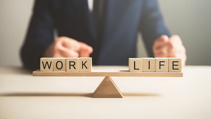 A balanced seesaw shows “WORK” and “LIFE”. work life balance concept