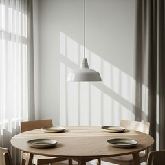 Minimalist dining room with a round wooden table and pendant lamp.