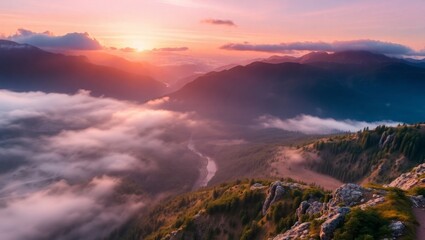 Stunning mountain landscape at sunrise with fog and clouds