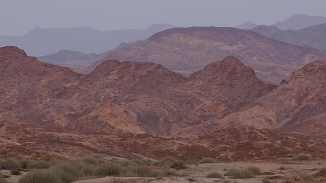 panorama of red mountain ranges in early morning light, pan shot  804