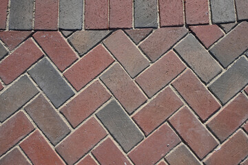 Obraz premium Close-Up View of Paver Bricks Laid in a Detailed Herringbone Pattern on a Walkway