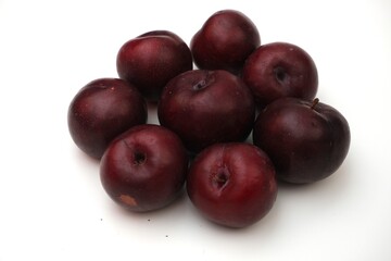 Fresh ripe red plums close-up for healthy eating	
