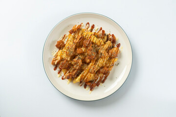 Crunchy Chicken Loaded Fries, Loaded Fries with Chicken topped with creamy mayonnaise and savory sauce, creating a delicious comfort food dish perfect for snack on white plate.