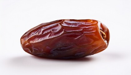 a single medjool date with its wrinkled skin in clear focus against a white background in studio shot