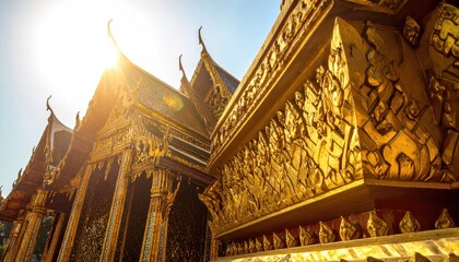 Golden temple architecture bathed in bright sunlight with intricate carvings and ornate details in Thailand on a clear day