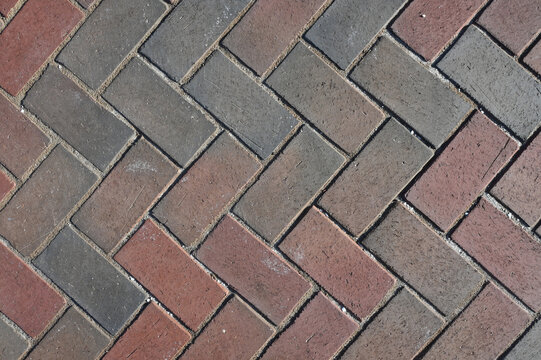 Close-Up View of Paver Bricks Laid in a Detailed Herringbone Pattern on a Walkway