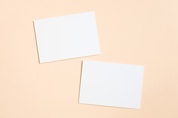 Blank white cards positioned on a soft peach background, creating a minimalistic and clean design, ideal for mock up presentations and creative projects