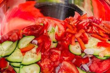 Different sliced fresh vegetables in stainless steel bowl close-up