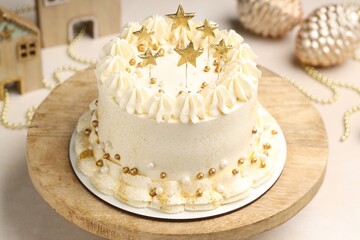 Delicious cake with Christmas decor on beige table, closeup