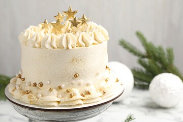Delicious cake with Christmas decor on white table, closeup