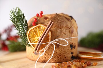 Christmas food. Delicious Panettone cake, ingredients and festive decor on table, closeup