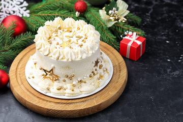 Delicious cake with Christmas decor on black table, closeup