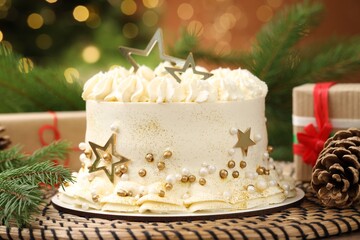 Delicious cake with Christmas decor on wooden table against blurred lights, closeup