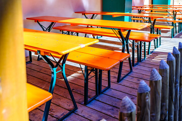 wooden benches and tables at a typical bavarian beergarden