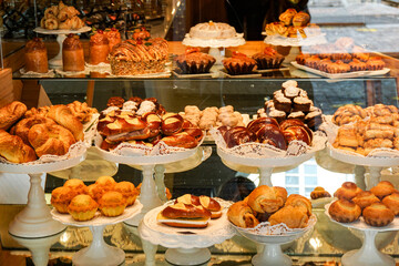 A bakery display case with a variety of pastries and cakes