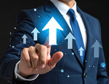 Businessman pointing at glowing upward arrows symbolizing business growth and success.