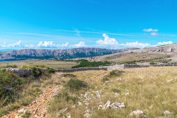 Sunny day in vast european mountain landscape with blue sky. Hike from Baška to Vela Luka