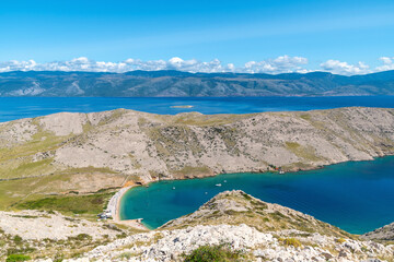 Scenic view of pristine beach and rocky coastline with azure waters. Vela Luka beach, Krk island, Croatia