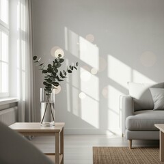 Sunlit minimalist living room interior with eucalyptus branches in a vase.