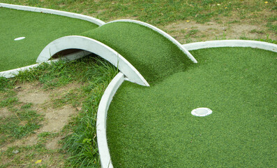 Mini golf lane with artificial turf and hole horizontal