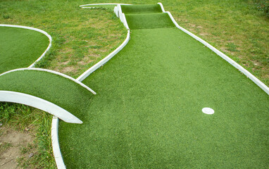 Mini golf lane with artificial turf and hole horizontal