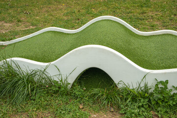 Mini golf lane with wavy hills and tunnel horizontal
