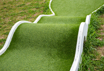 Mini golf lane with wavy hills and tunnel horizontal