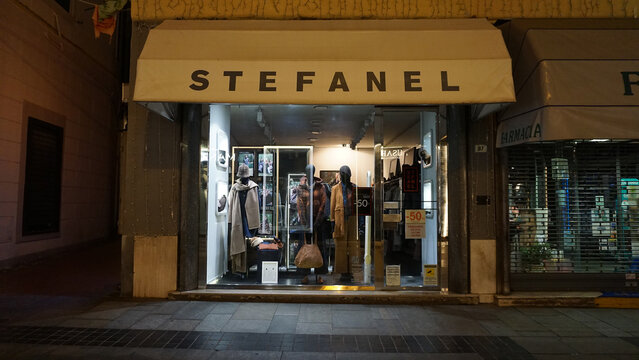 Sanremo, Italy - September 28, 2025: Stefanel storefront sign with neon red design on urban street at Italy.